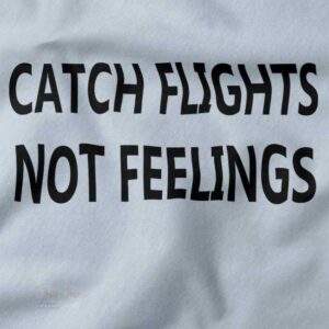 Graphic wanderlust T-shirt featuring Catch Flights Not Feelings text